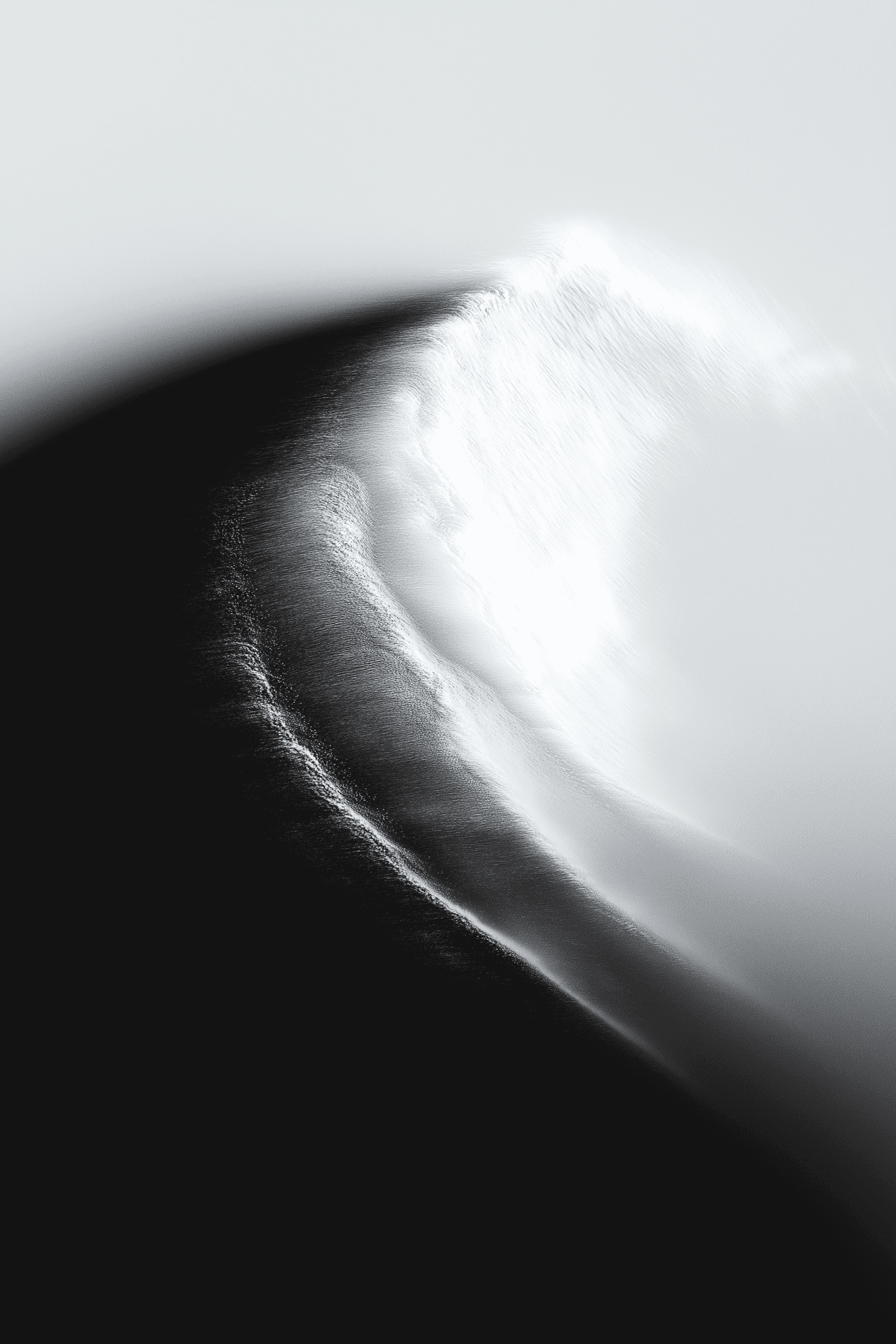Abstract black-and-white image with a sweeping curve resembling a wave or dune